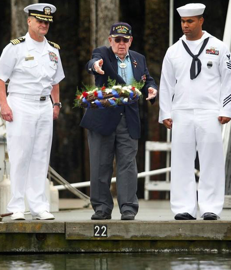 Navy Personnel and a Veteran Offering a Wreath